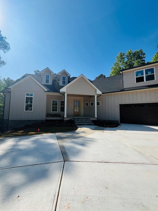 280 Greystone Dr, Milledgeville, GA 31061 - view of front facade with board and batten siding, covered porch, driveway, roof with shingles, and a garage