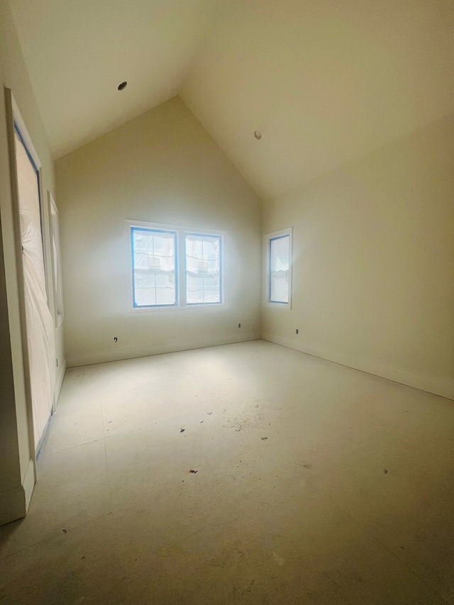 empty room featuring high vaulted ceiling