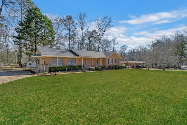 110 Westminster Dr, Eatonton, GA 31024 - view of front of property with brick siding, concrete driveway, and a front lawn