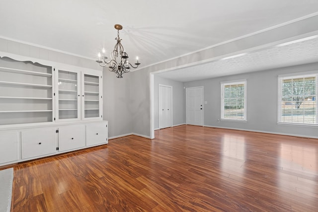 110 Westminster Dr, Eatonton, GA 31024 - unfurnished room with baseboards, ornamental molding, wood finished floors, and a notable chandelier
