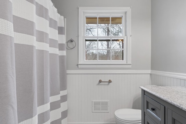 110 Westminster Dr, Eatonton, GA 31024 - full bathroom featuring a wainscoted wall, visible vents, a shower with shower curtain, toilet, and vanity
