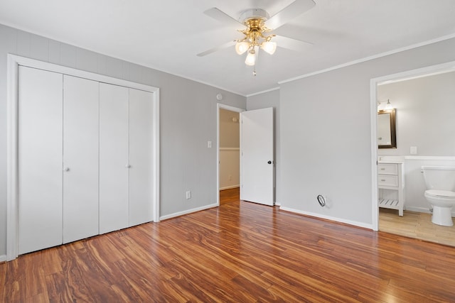 110 Westminster Dr, Eatonton, GA 31024 - unfurnished bedroom featuring ornamental molding, connected bathroom, a closet, and wood finished floors
