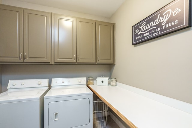 clothes washing area featuring cabinets and washing machine and clothes dryer