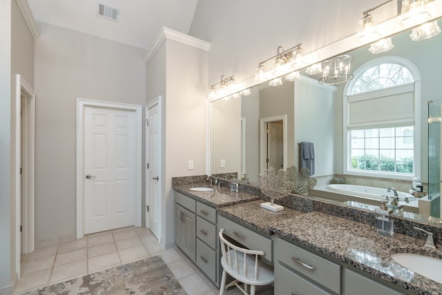 bathroom with vanity, an inviting chandelier, tile patterned flooring, a high ceiling, and a tub