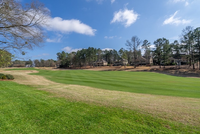 view of property's community with a lawn