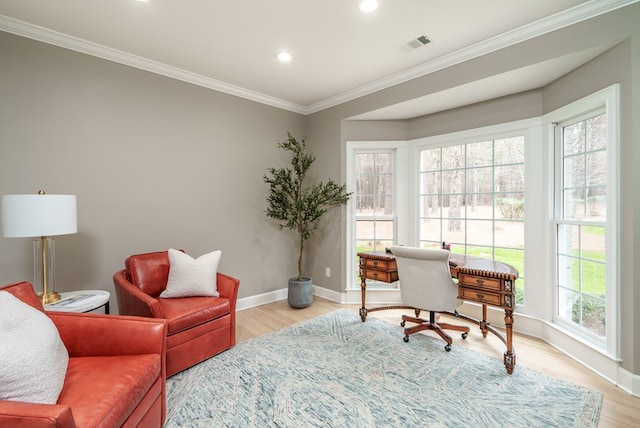 office space with light hardwood / wood-style floors and ornamental molding