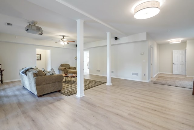 living room featuring ceiling fan and light hardwood / wood-style flooring