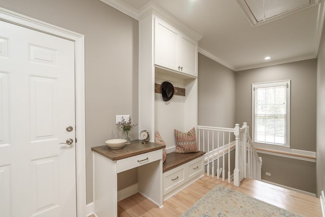 mudroom with light hardwood / wood-style floors and crown molding