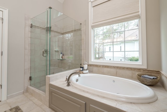 bathroom with tile patterned floors, plenty of natural light, and plus walk in shower