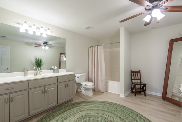 full bathroom featuring shower / bath combination with curtain, vanity, hardwood / wood-style flooring, and toilet