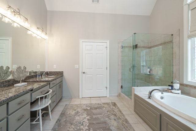 bathroom featuring tile patterned floors, vanity, and separate shower and tub