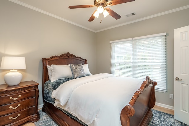 bedroom with ceiling fan, crown molding, and hardwood / wood-style flooring