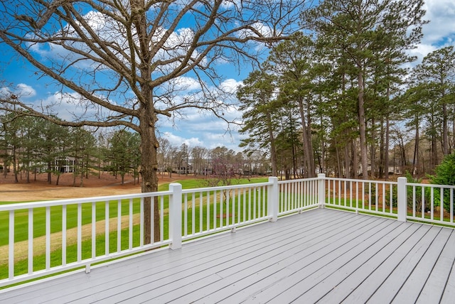 wooden terrace with a lawn