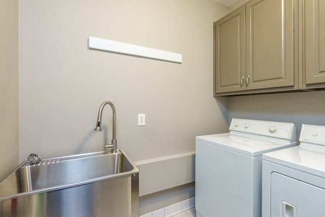 laundry room with cabinets, separate washer and dryer, and sink