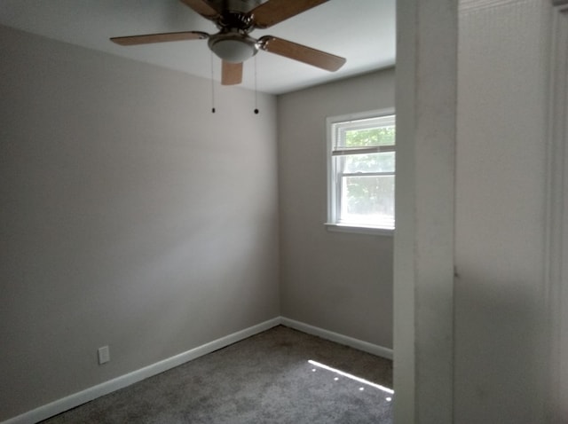 unfurnished room featuring dark carpet and ceiling fan