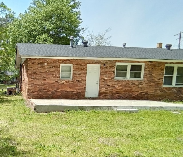 back of house with a lawn