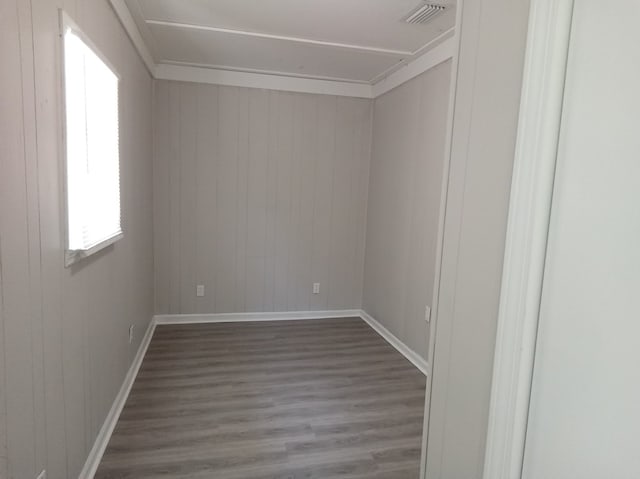 spare room with wood walls and dark hardwood / wood-style floors