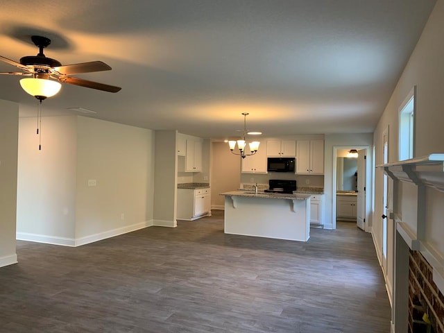 461 Riley Cir, Milledgeville, GA 31061 - kitchen with black microwave, stove, a chandelier, white cabinetry, and dark wood-type flooring