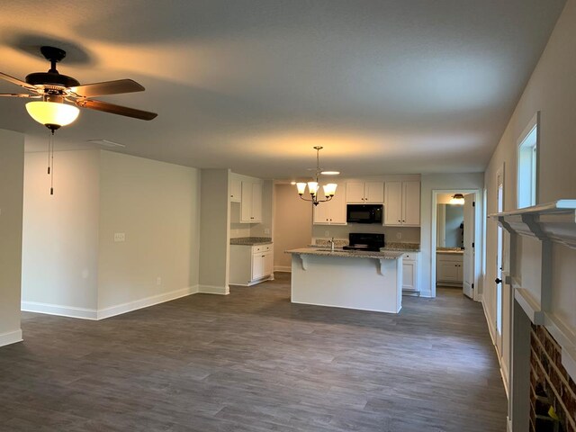 461 Riley Cir, Milledgeville, GA 31061 - kitchen featuring black microwave, a chandelier, stove, and dark wood finished floors