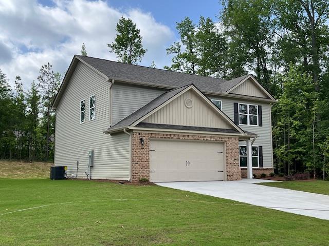 461 Riley Cir, Milledgeville, GA 31061 - view of front facade featuring brick siding, concrete driveway, an attached garage, and a front yard