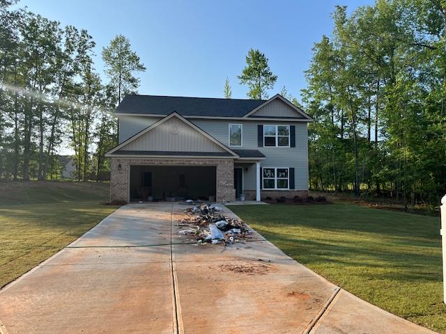 461 Riley Cir, Milledgeville, GA 31061 - view of front of property with concrete driveway, a front yard, and an attached garage