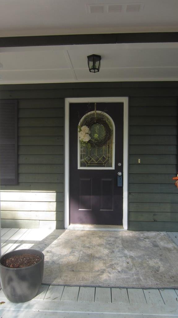 131 NE Carriage Ct, Milledgeville, GA 31061 - view of exterior entry with a porch and visible vents