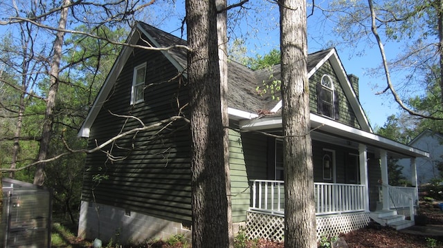 131 NE Carriage Ct, Milledgeville, GA 31061 - view of property exterior with roof with shingles and covered porch
