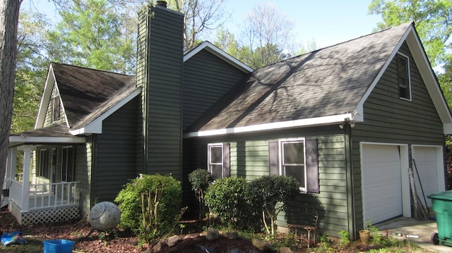 131 NE Carriage Ct, Milledgeville, GA 31061 - view of home's exterior featuring a chimney, a garage, and roof with shingles
