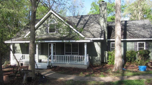 131 NE Carriage Ct, Milledgeville, GA 31061 - view of front facade featuring roof with shingles, a chimney, and covered porch