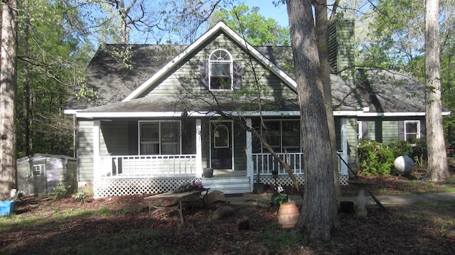 131 NE Carriage Ct, Milledgeville, GA 31061 - view of front of property featuring an outbuilding, a porch, and a chimney