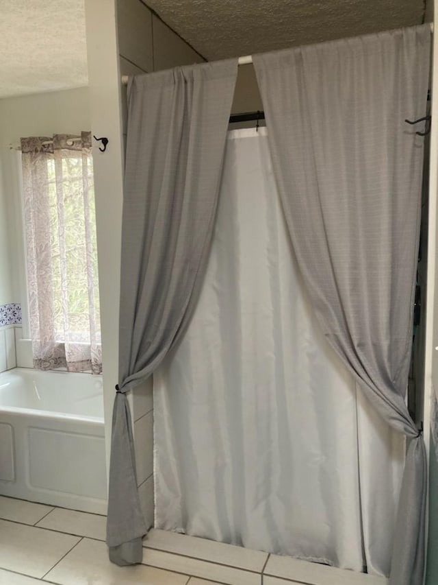 131 NE Carriage Ct, Milledgeville, GA 31061 - full bathroom with a bath, tile patterned floors, and a textured ceiling