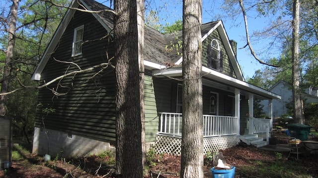 131 NE Carriage Ct, Milledgeville, GA 31061 - view of side of property featuring roof with shingles and covered porch
