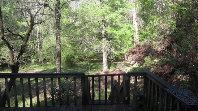 131 NE Carriage Ct, Milledgeville, GA 31061 - wooden terrace with a wooded view
