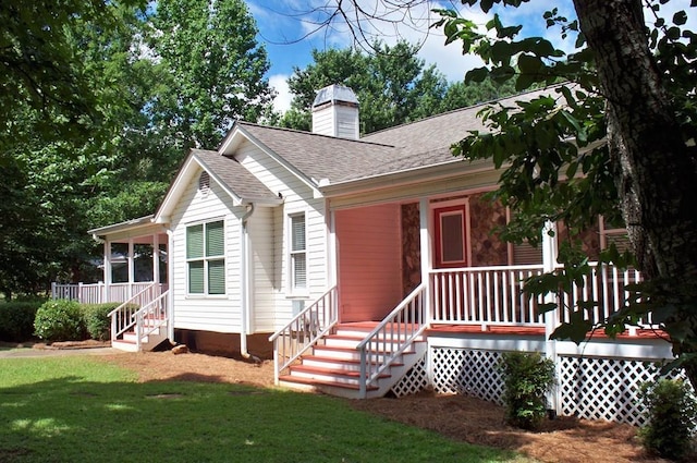 121 Long Island Dr, Eatonton, GA 31024 - ranch-style home with covered porch, a front yard, a shingled roof, and a chimney