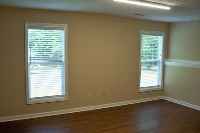121 Long Island Dr, Eatonton, GA 31024 - unfurnished room with dark wood-style flooring and a textured ceiling