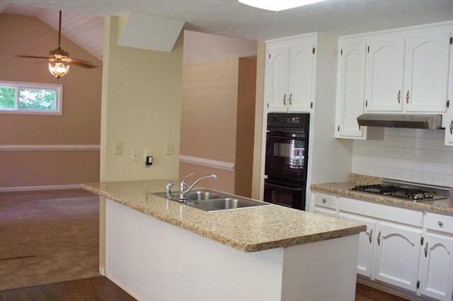 121 Long Island Dr, Eatonton, GA 31024 - kitchen featuring stainless steel gas cooktop, under cabinet range hood, white cabinetry, and lofted ceiling