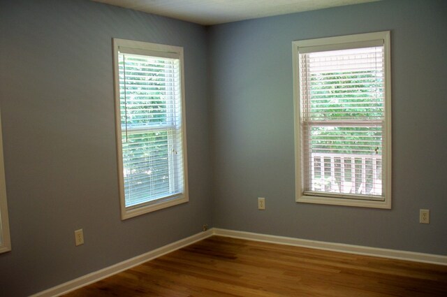 121 Long Island Dr, Eatonton, GA 31024 - empty room featuring plenty of natural light and wood finished floors