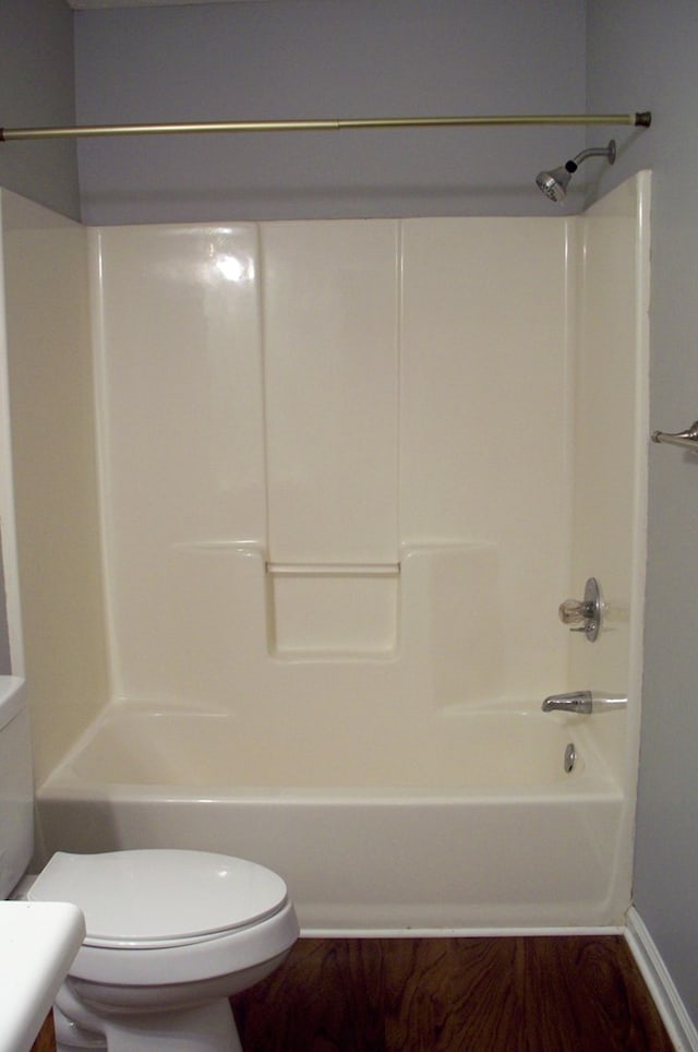121 Long Island Dr, Eatonton, GA 31024 - bathroom with washtub / shower combination and wood finished floors