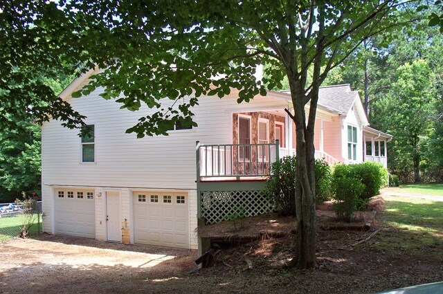 121 Long Island Dr, Eatonton, GA 31024 - view of front of house featuring dirt driveway, a garage, and a wooden deck
