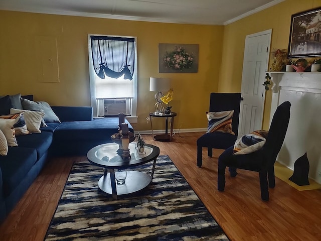 living room with cooling unit, wood-type flooring, and ornamental molding