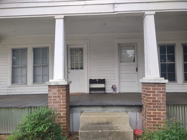 view of exterior entry featuring a porch