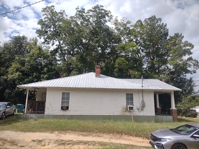 view of side of home with a porch and cooling unit