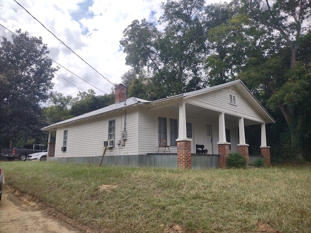 view of side of property featuring a porch and cooling unit