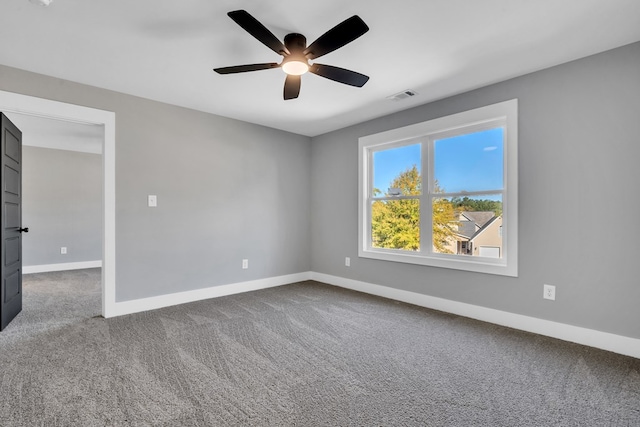 carpeted spare room with ceiling fan