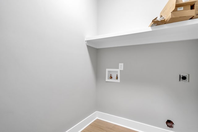 clothes washing area with hardwood / wood-style floors, washer hookup, and hookup for an electric dryer