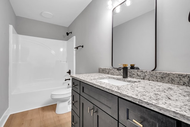 full bathroom featuring vanity, toilet, wood-type flooring, and bathtub / shower combination