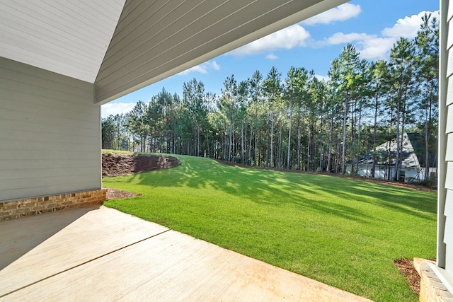 view of yard featuring a water view and a patio area