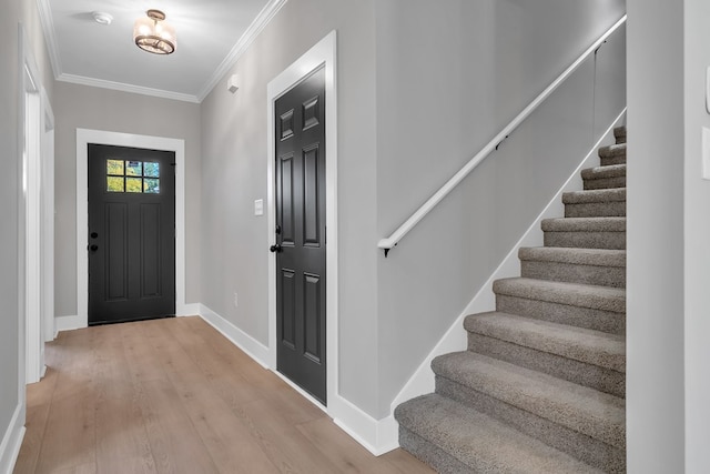 entrance foyer featuring light hardwood / wood-style flooring and ornamental molding