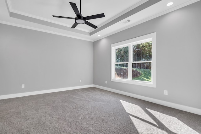 unfurnished room with ceiling fan, carpet floors, crown molding, and a tray ceiling