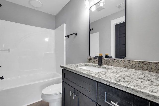 full bathroom with vanity, toilet, and  shower combination